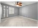 A spacious bedroom featuring tiled floors, a decorative ceiling fan, and plantation shutters at 5906 Sw 108Th St, Ocala, FL 34476