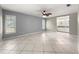 Serene bedroom with tile flooring, ceiling fan, and access to the en-suite bathroom at 5906 Sw 108Th St, Ocala, FL 34476
