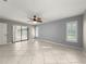 Bedroom with tile floors, ceiling fan, and a sliding glass door to the lanai at 5906 Sw 108Th St, Ocala, FL 34476