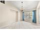 Dining room with tiled floors, large windows, and elegant chandelier lighting at 5906 Sw 108Th St, Ocala, FL 34476