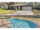 Charming single-story home featuring a black brick facade and a well-maintained front yard with green grass and a private pool at 5906 Sw 108Th St, Ocala, FL 34476