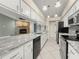 Spacious kitchen with granite countertops, stainless steel appliances, and a stone fireplace at 5906 Sw 108Th St, Ocala, FL 34476