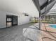 Large, covered patio leading to a screened pool area with tiled flooring at 5906 Sw 108Th St, Ocala, FL 34476