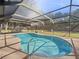 Screened-in pool with a metal safety railing and view of the green backyard at 5906 Sw 108Th St, Ocala, FL 34476