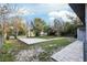 Spacious fenced backyard featuring a concrete patio and lush greenery at 644 Sw 2Nd St, Ocala, FL 34471