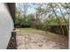 Fenced backyard with small garden bed, mature trees, and green grass at 644 Sw 2Nd St, Ocala, FL 34471