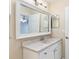 Bathroom vanity with double sink and a large framed mirror with overhead lighting at 644 Sw 2Nd St, Ocala, FL 34471