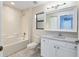 Bright bathroom featuring a tub/shower, a granite countertop, and a large, well-lit mirror at 644 Sw 2Nd St, Ocala, FL 34471