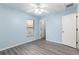 Bedroom with blue walls, ceiling fan, window, and gray laminate wood flooring at 644 Sw 2Nd St, Ocala, FL 34471