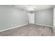 Spacious bedroom with gray walls, ceiling fan, and laminate wood flooring at 644 Sw 2Nd St, Ocala, FL 34471