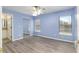 Bedroom with wood floors, large windows, and light-blue colored walls at 644 Sw 2Nd St, Ocala, FL 34471