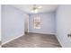 Bedroom with a ceiling fan, window, and wood-look flooring, bathed in soft, natural light at 644 Sw 2Nd St, Ocala, FL 34471