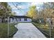 Fenced front yard with a long concrete driveway leading to the house at 644 Sw 2Nd St, Ocala, FL 34471