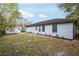 Back exterior of the house with gray paint, and a shed in the backyard at 644 Sw 2Nd St, Ocala, FL 34471