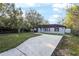 Single-story house featuring a long driveway and manicured lawn at 644 Sw 2Nd St, Ocala, FL 34471