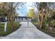View of the home from gated driveway, includes mailbox at 644 Sw 2Nd St, Ocala, FL 34471
