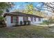 Charming home exterior with red shutters, a well-kept lawn, and manicured shrubbery at 644 Sw 2Nd St, Ocala, FL 34471