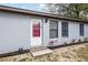 Front entrance featuring a secure screen door and new landscaping, adding curb appeal at 644 Sw 2Nd St, Ocala, FL 34471
