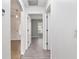 Hallway featuring doors and stylish flooring, seamlessly connecting various spaces in the house at 644 Sw 2Nd St, Ocala, FL 34471