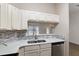 Modern kitchen featuring stainless steel appliances, stone countertops, and updated backsplash at 644 Sw 2Nd St, Ocala, FL 34471