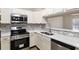 Modern kitchen featuring stainless steel appliances, quartz countertops, and tile backsplash at 644 Sw 2Nd St, Ocala, FL 34471