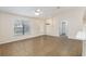 Inviting living room featuring a ceiling fan, tiled floor, and an ornate glass-inset front door at 644 Sw 2Nd St, Ocala, FL 34471