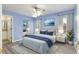 Relaxing main bedroom featuring wood floors, ceiling fan, and bright, light-blue colored walls at 644 Sw 2Nd St, Ocala, FL 34471