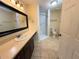 Well-lit bathroom with a single vanity sink and shower at 6611 Sw 80Th Ave, Ocala, FL 34481