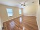 Bright bedroom with two windows, wood-look flooring, and ample natural light at 6611 Sw 80Th Ave, Ocala, FL 34481