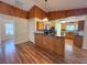 Charming kitchen with wood cabinets, granite countertops, and wood-look flooring at 6611 Sw 80Th Ave, Ocala, FL 34481