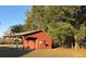 The large, red pavilion with the green roof has a cement floor and plenty of shade at 6611 Sw 80Th Ave, Ocala, FL 34481