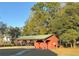 A large, red pavilion with a green roof is a great place to gather for fun activities at 6611 Sw 80Th Ave, Ocala, FL 34481