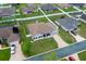 Aerial view of the home showing the roof, landscaping, driveway, and surrounding neighborhood at 6875 Se 11Th Pl, Ocala, FL 34472