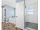 Bathroom showcasing a separate soaking tub and a glass enclosed shower with light tile at 6875 Se 11Th Pl, Ocala, FL 34472