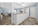Bathroom featuring double sink vanity, granite countertops, white cabinets, and wood look floors at 6875 Se 11Th Pl, Ocala, FL 34472
