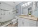 Bathroom featuring a glass enclosed shower, wood look tile floors, and granite vanity with white cabinets at 6875 Se 11Th Pl, Ocala, FL 34472