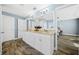 En Suite bath featuring double sink vanity, granite countertops, white cabinets, and wood look floors at 6875 Se 11Th Pl, Ocala, FL 34472