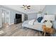 Main bedroom featuring wood floors, a large dresser, walk in closet and ensuite bathroom at 6875 Se 11Th Pl, Ocala, FL 34472