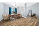 Open-concept dining room with wood-look floors and bright blue walls and window coverings at 6875 Se 11Th Pl, Ocala, FL 34472