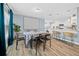 Bright dining area near kitchen featuring wood-look floors and bright light at 6875 Se 11Th Pl, Ocala, FL 34472
