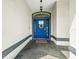 Beautiful blue front door with modern hardware, wreath, welcome mat, and stone tile entryway at 6875 Se 11Th Pl, Ocala, FL 34472