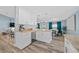 Elegant kitchen featuring an island with pendant lighting, wood-look floors, and stainless steel appliances at 6875 Se 11Th Pl, Ocala, FL 34472