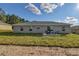 Expansive backyard view with a patio, a lush lawn and a grey home exterior at 7772 Sw 146Th Lane Rd, Ocala, FL 34473