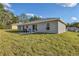Spacious backyard with lush green grass, patio area with furniture, perfect for outdoor enjoyment at 7772 Sw 146Th Lane Rd, Ocala, FL 34473