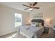 Comfortable bedroom with natural light, a ceiling fan, and neutral tones creating a peaceful retreat at 7772 Sw 146Th Lane Rd, Ocala, FL 34473