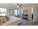 Bright bedroom with two large windows, a ceiling fan, and a doorway to a bathroom, offering space and convenience at 7772 Sw 146Th Lane Rd, Ocala, FL 34473