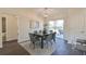 Elegant dining area with modern chandelier and sliding doors to the outdoor patio at 7772 Sw 146Th Lane Rd, Ocala, FL 34473