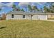 Charming single-story home showcasing a well-manicured lawn and neutral gray exterior paint at 7772 Sw 146Th Lane Rd, Ocala, FL 34473