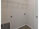 A functional laundry room with tile floors, utility connections, and convenient storage space at 7772 Sw 146Th Lane Rd, Ocala, FL 34473