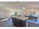 Spacious open-concept living area featuring modern lighting, a dining area, and a comfortable seating arrangement at 7772 Sw 146Th Lane Rd, Ocala, FL 34473